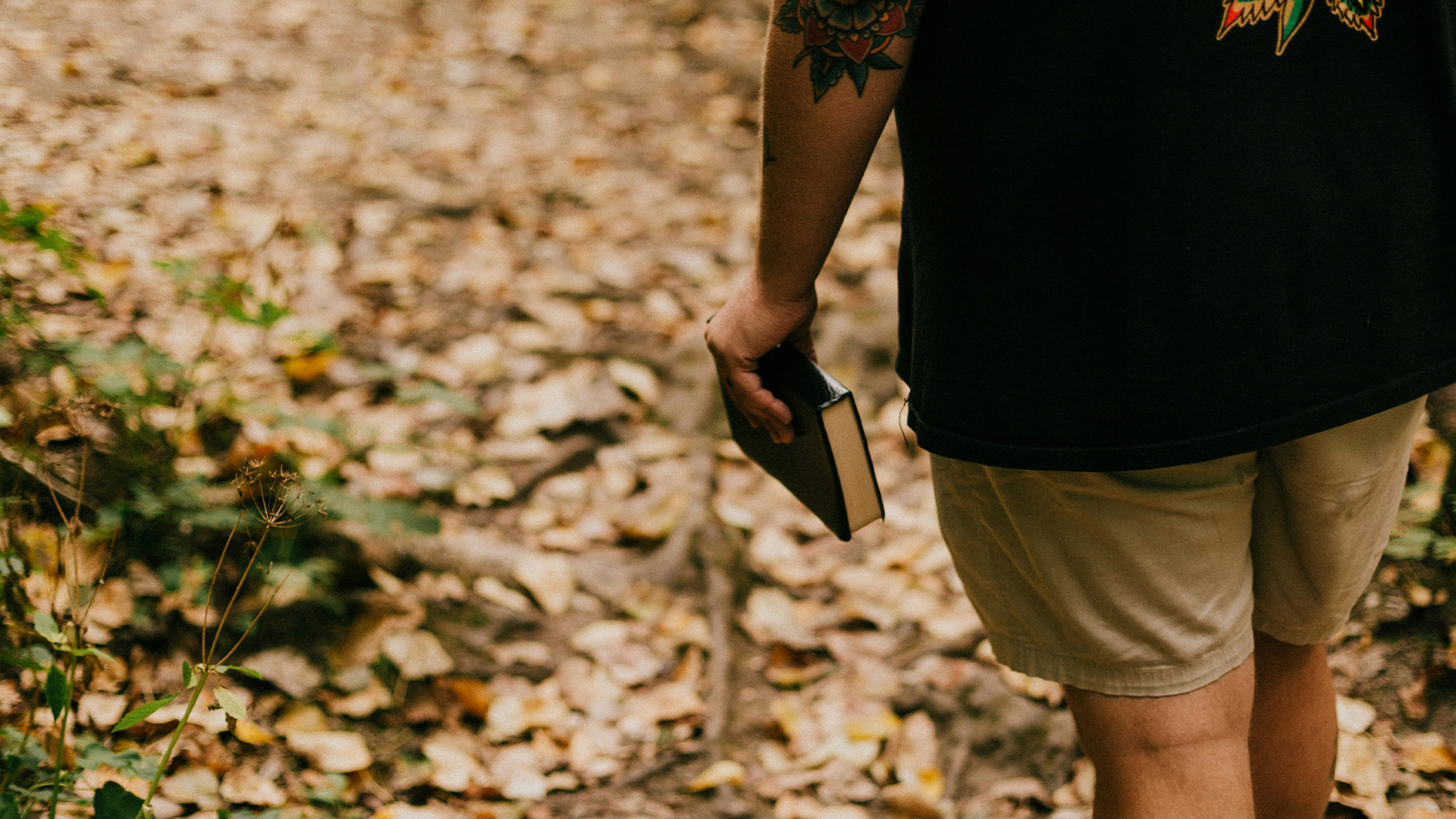 A person walking with a bible
