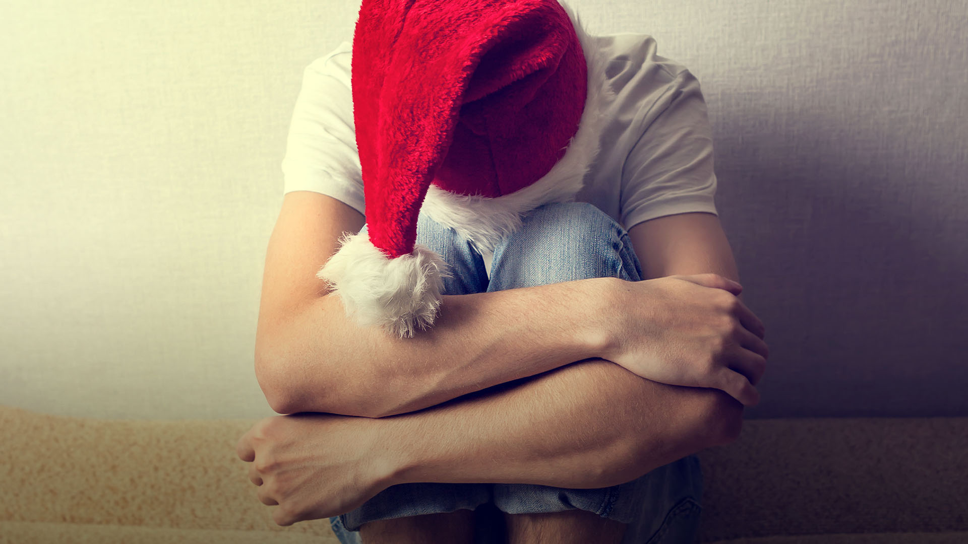 sad man with christmas hat on