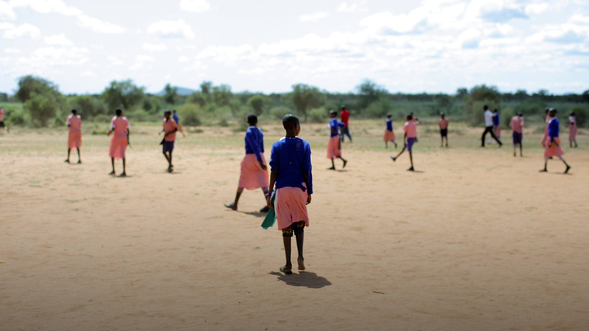 African children playing football outside together