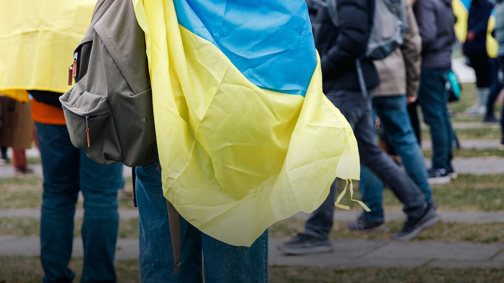 Refugees and protesters holding Ukrainian flags