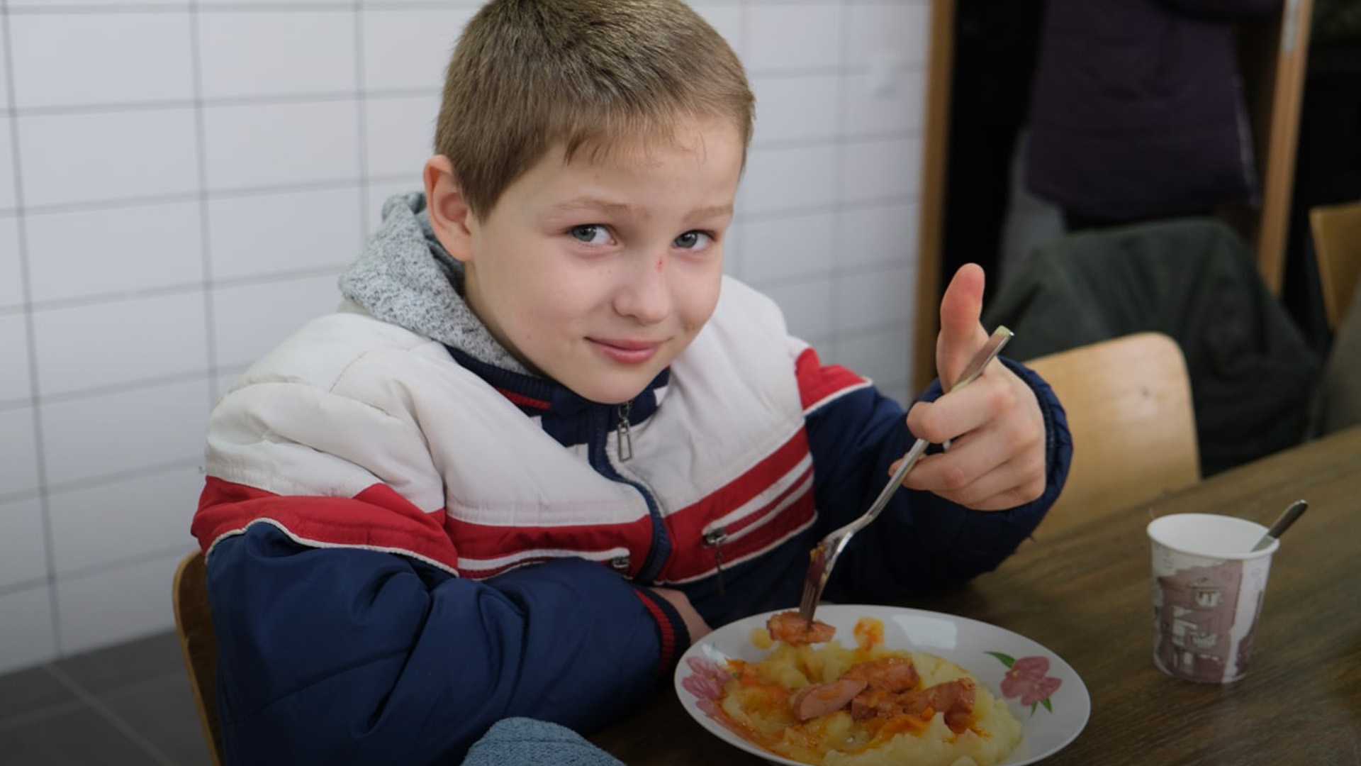 Ukrainian boy eating some food