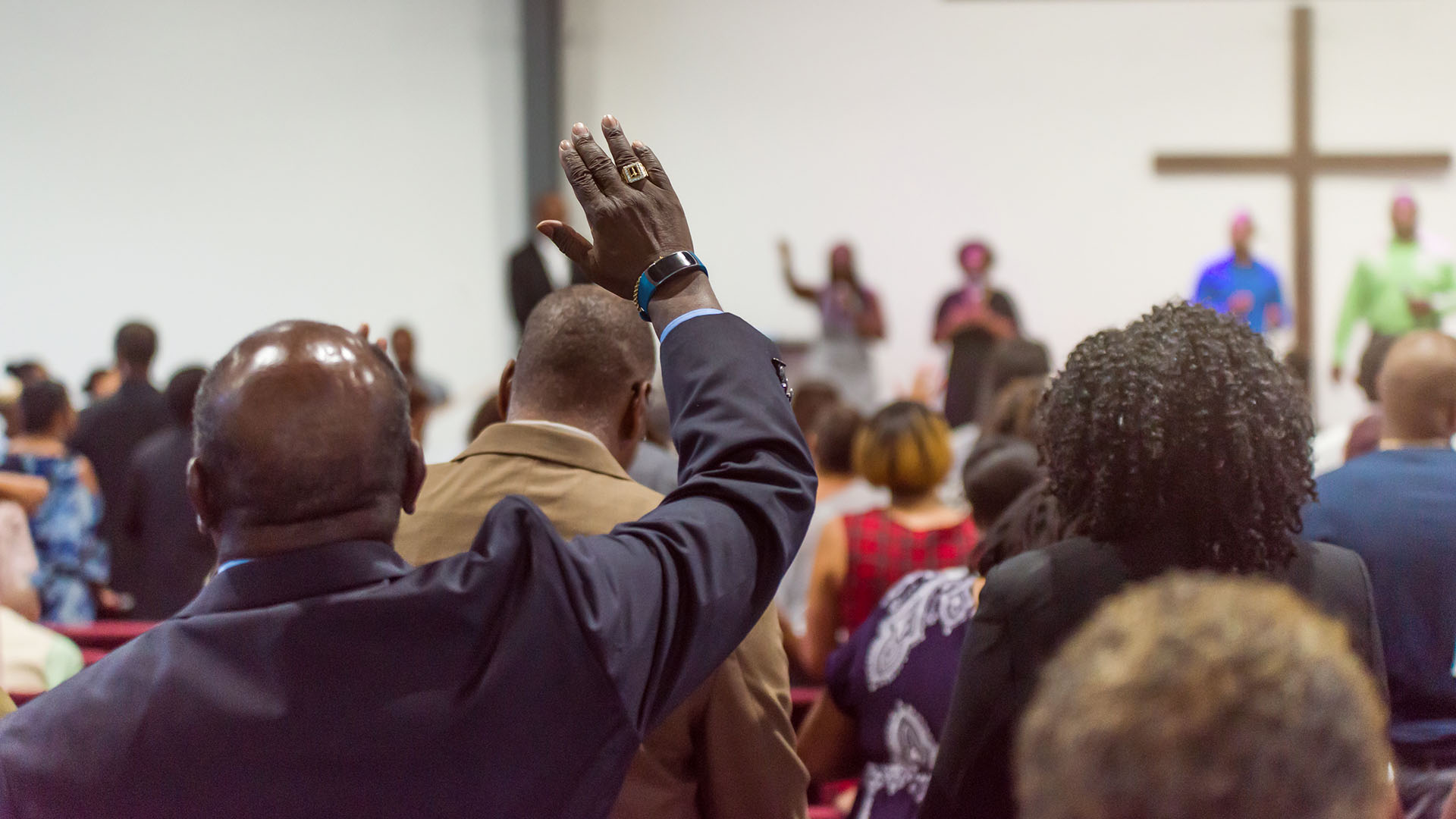 Man lifting his hand in worship at church