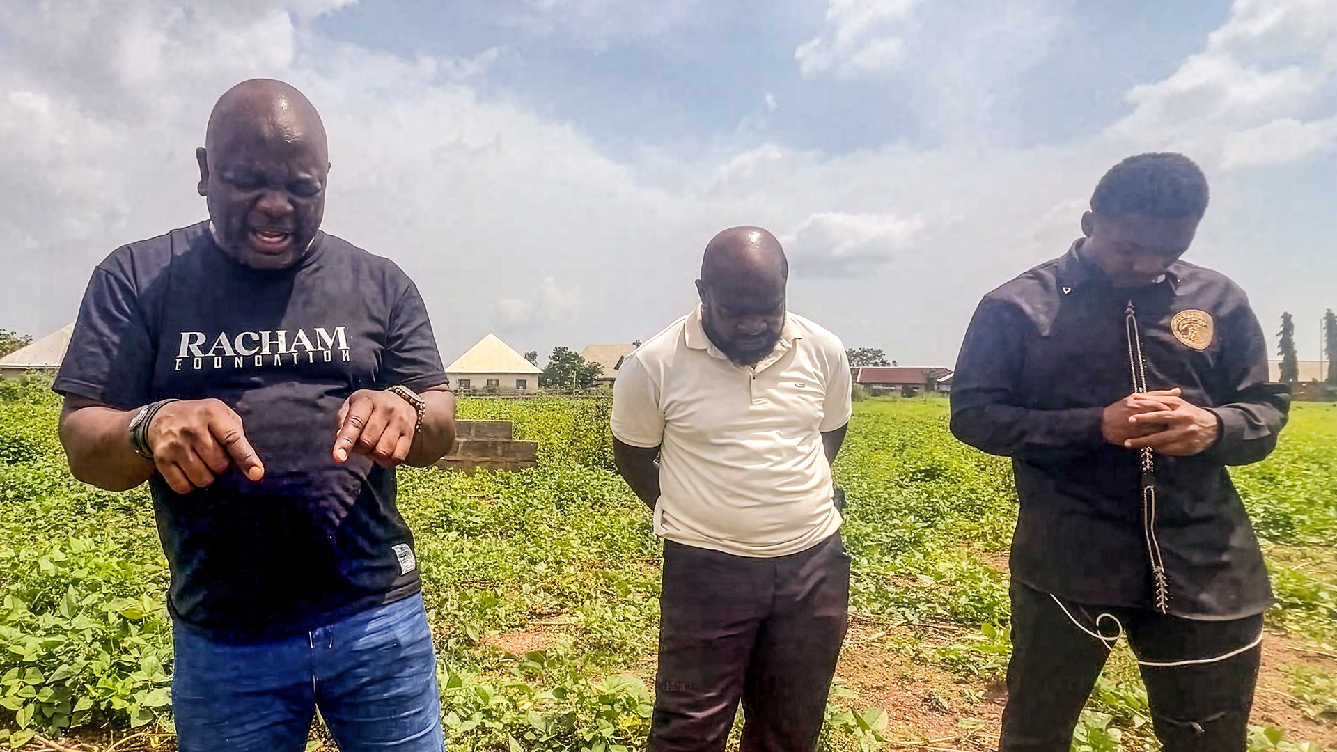 Pastor David leads his team in prayer on the grounds of the future care center site.