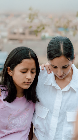 Image of two women praying