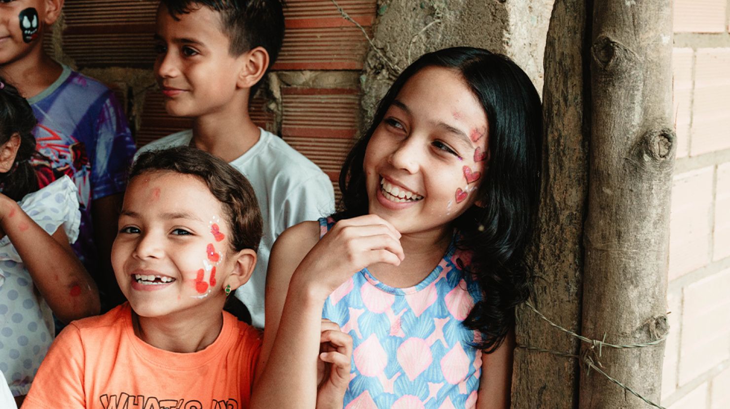 smiling Peruvian girls with face paint