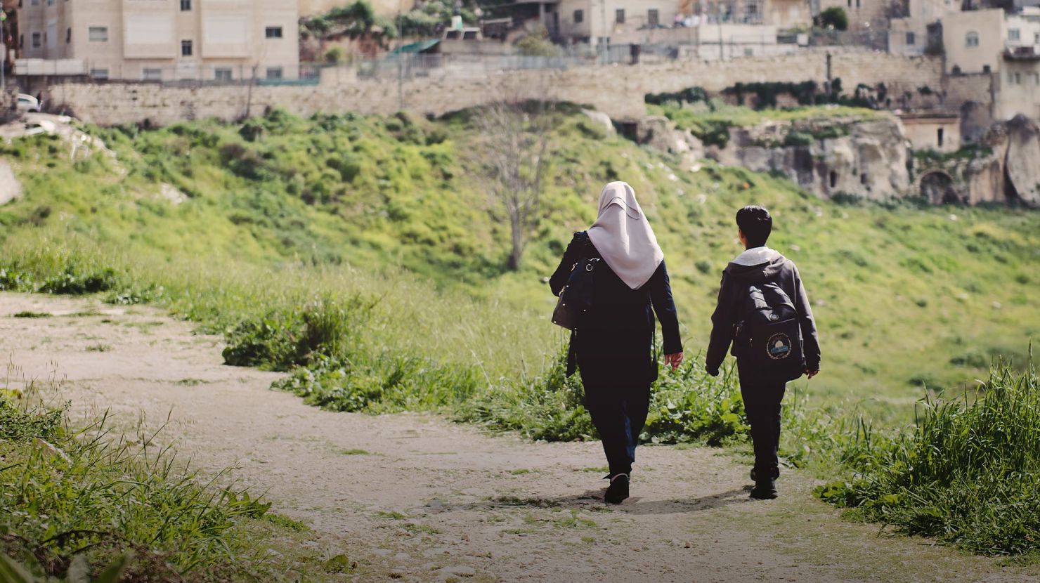 Woman and child walking down a path