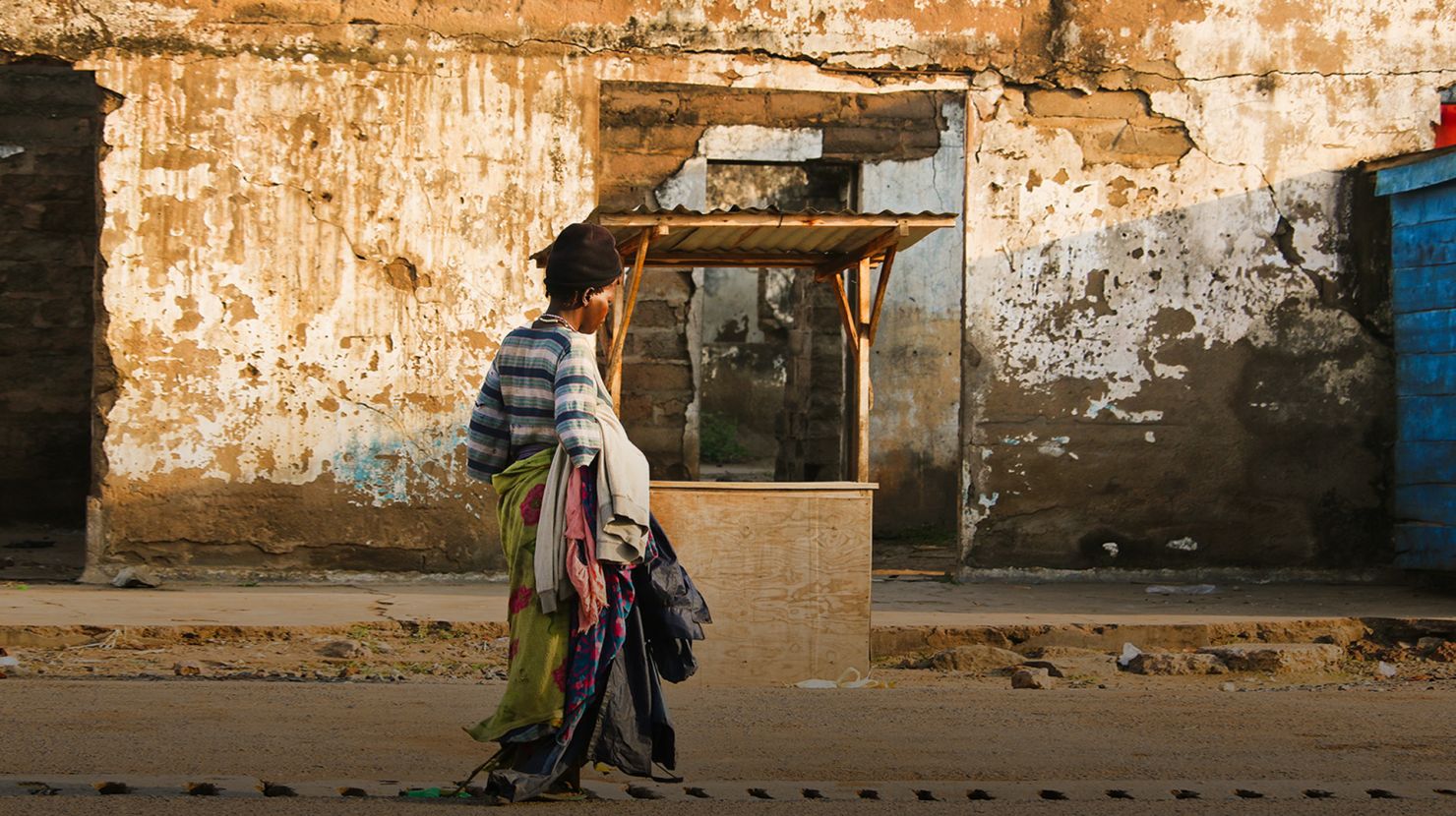 woman walking past well