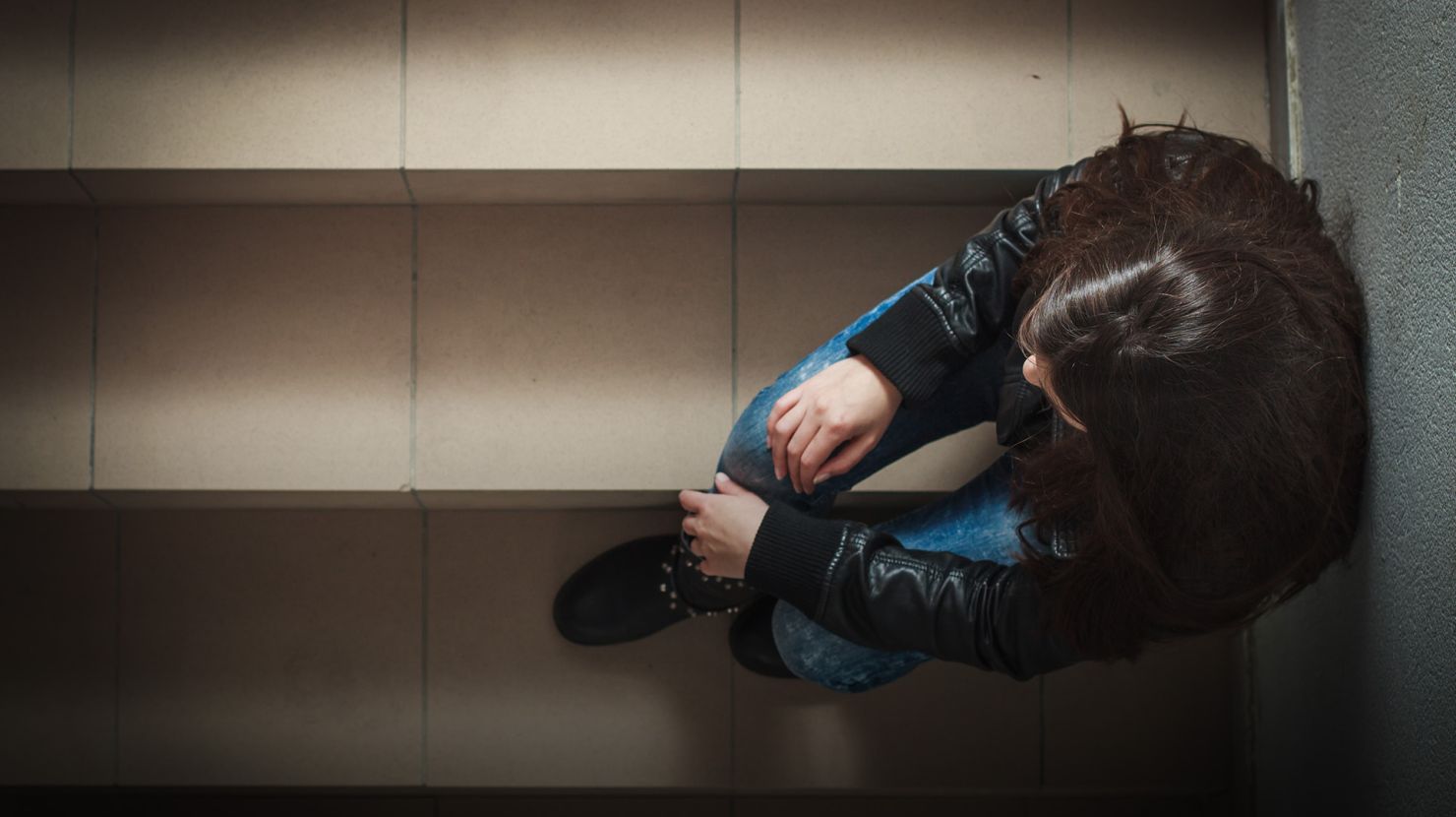 woman depressed sitting on stairs