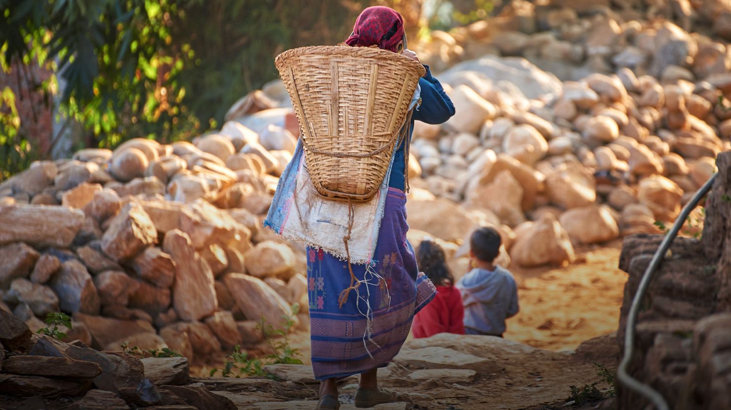 woman carrying a basket and walking with kids