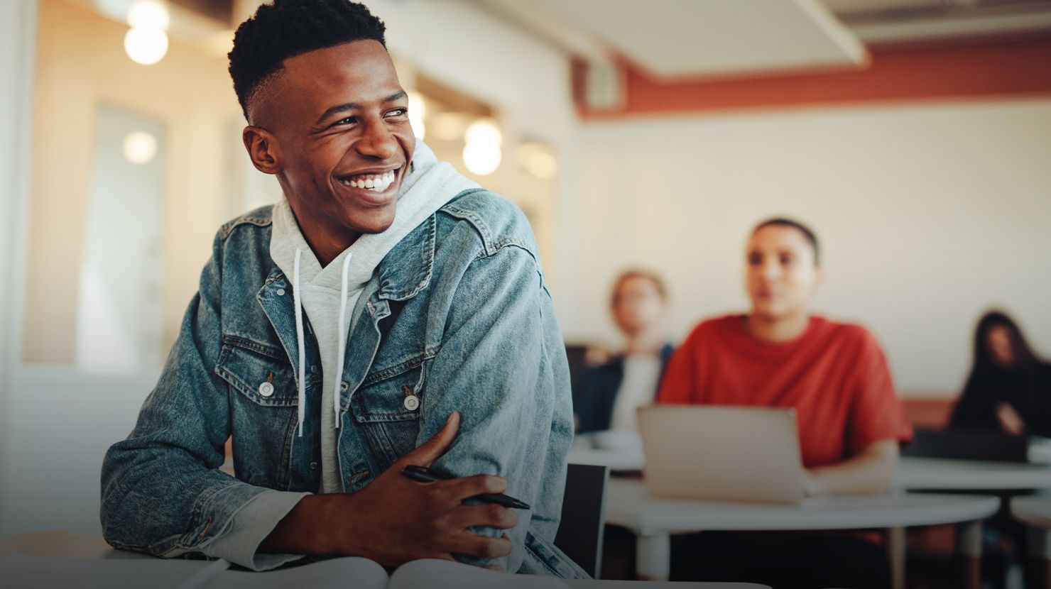young man sitting in classroom