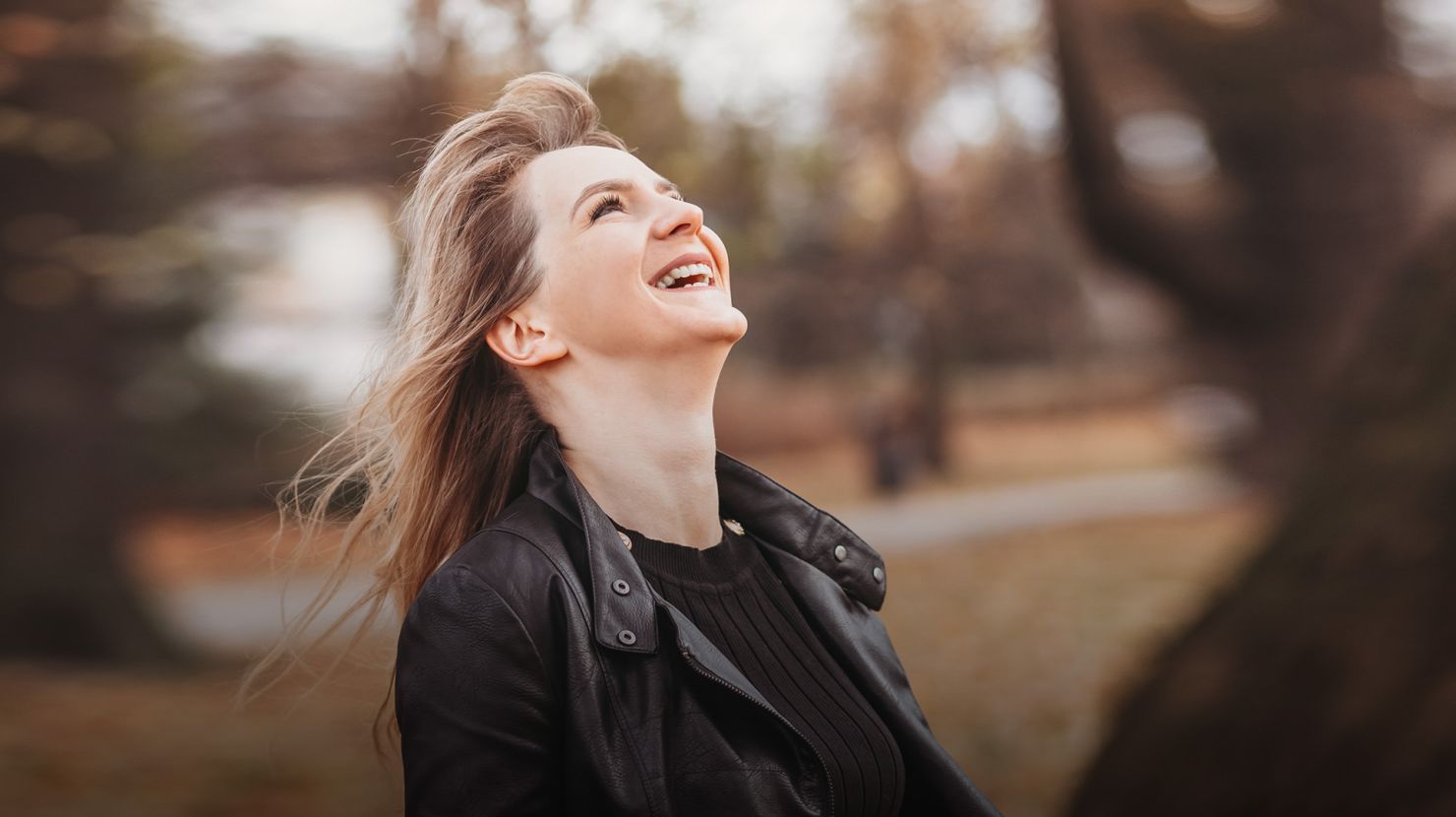 woman laughing in the forest