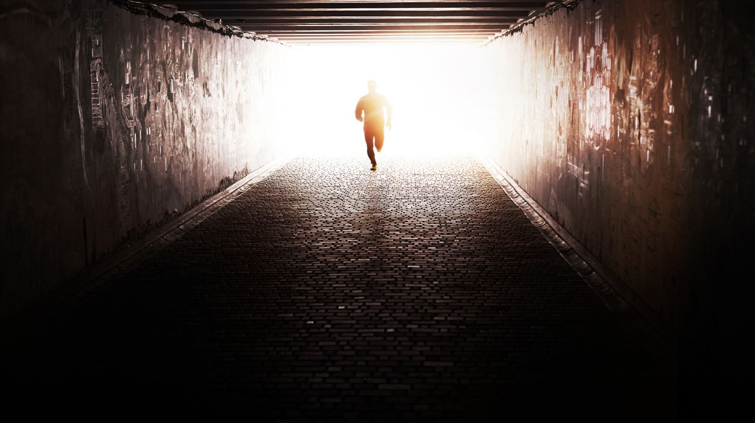 man running out of tunnel