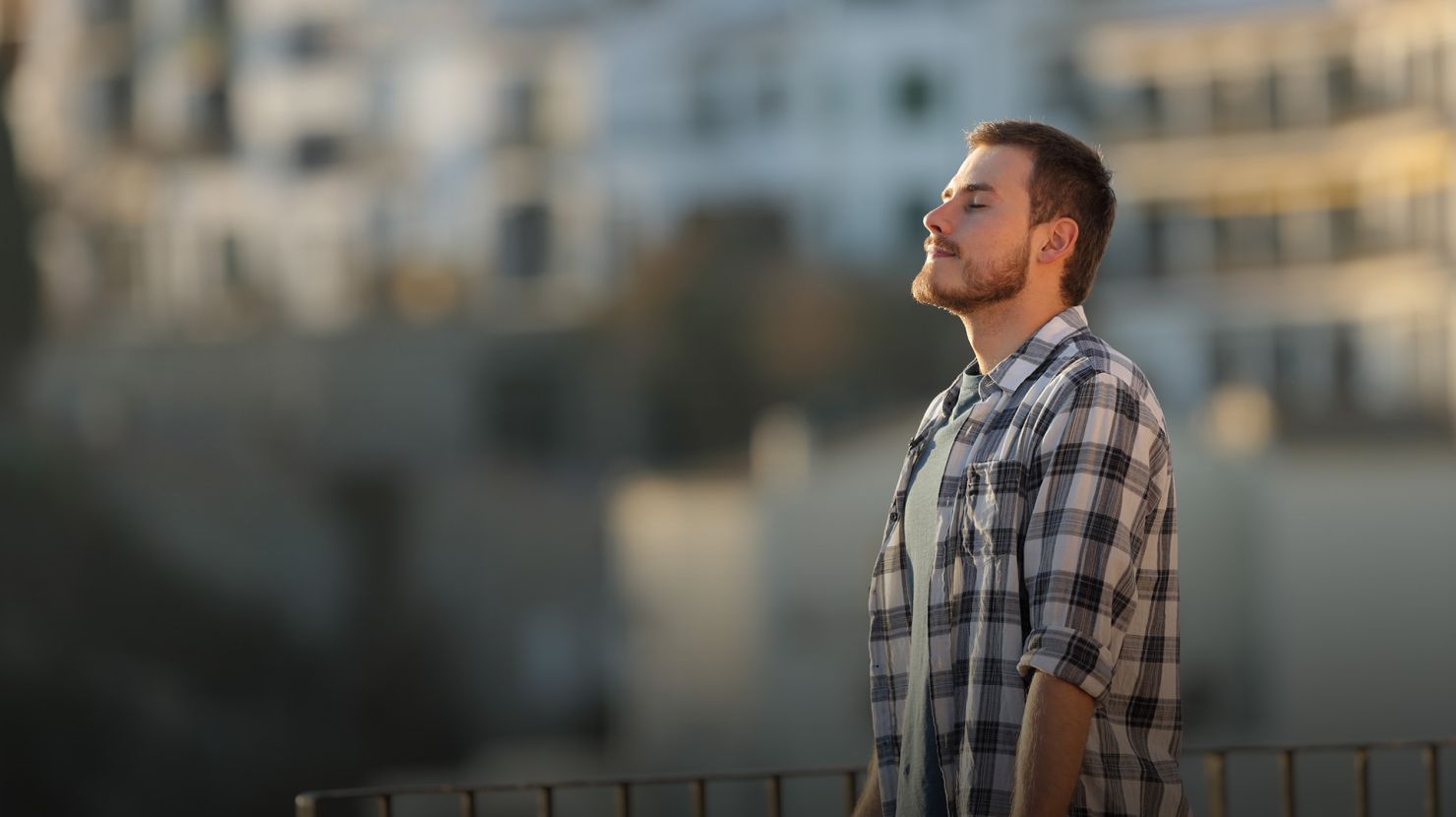 Relaxed man in a town breathing fresh air