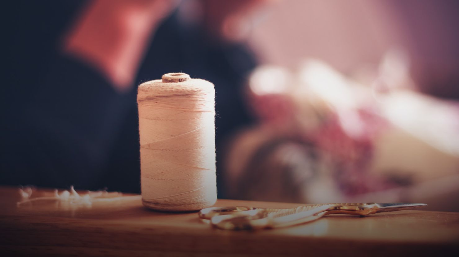Thread and sewing equipment with woman in background