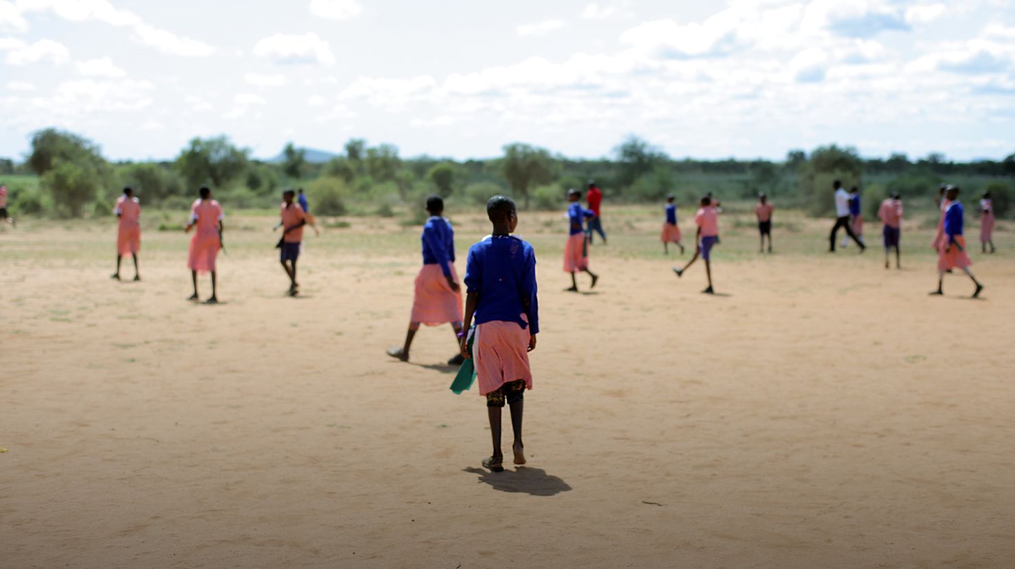 African children playing football outside together