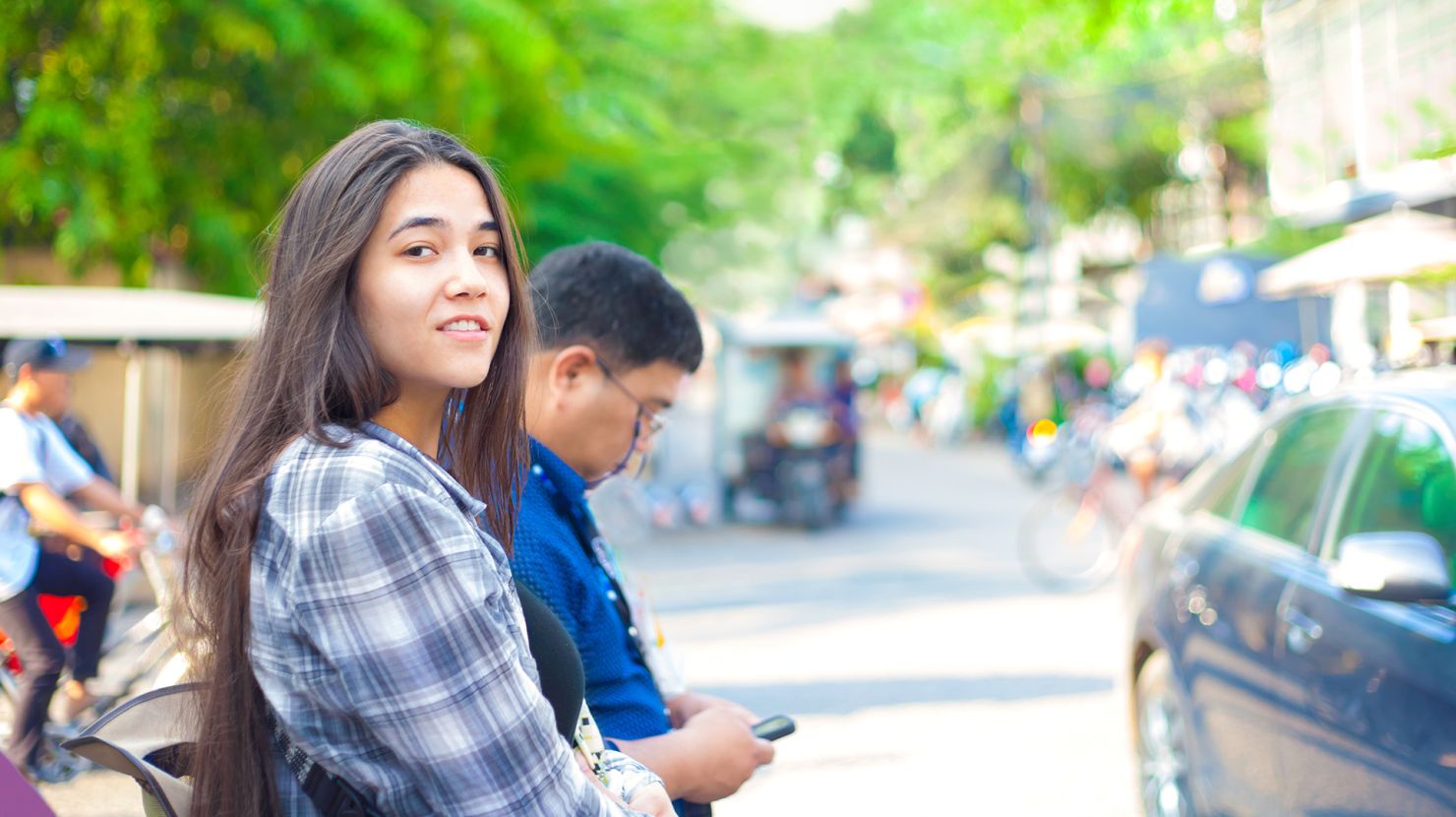 Girl tourist along streets of Phnom Pehn, Cambodia
