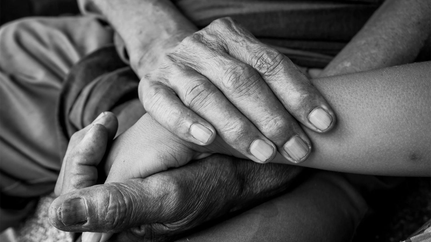 Two people holding hands