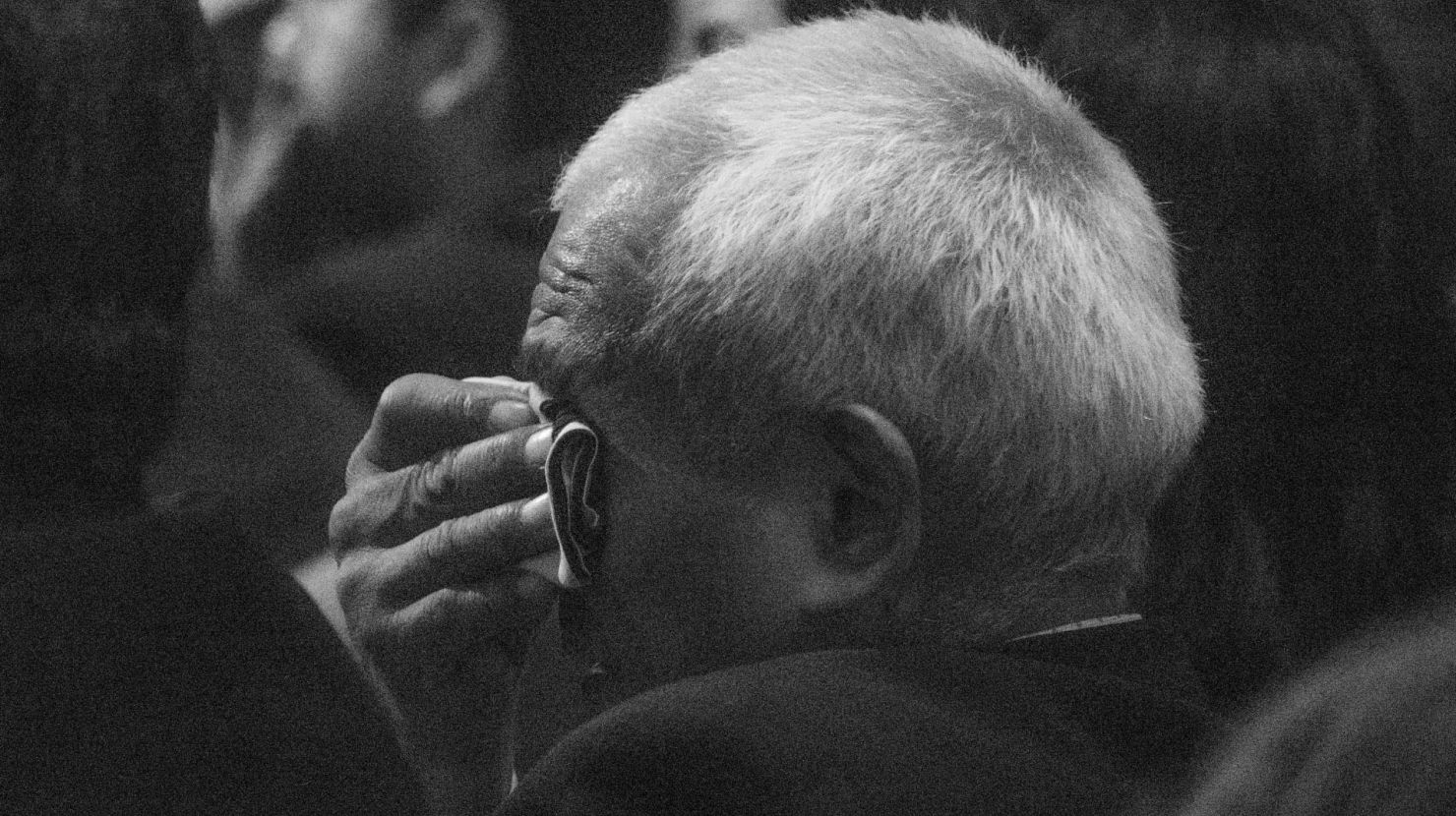 Man weeping and covering face