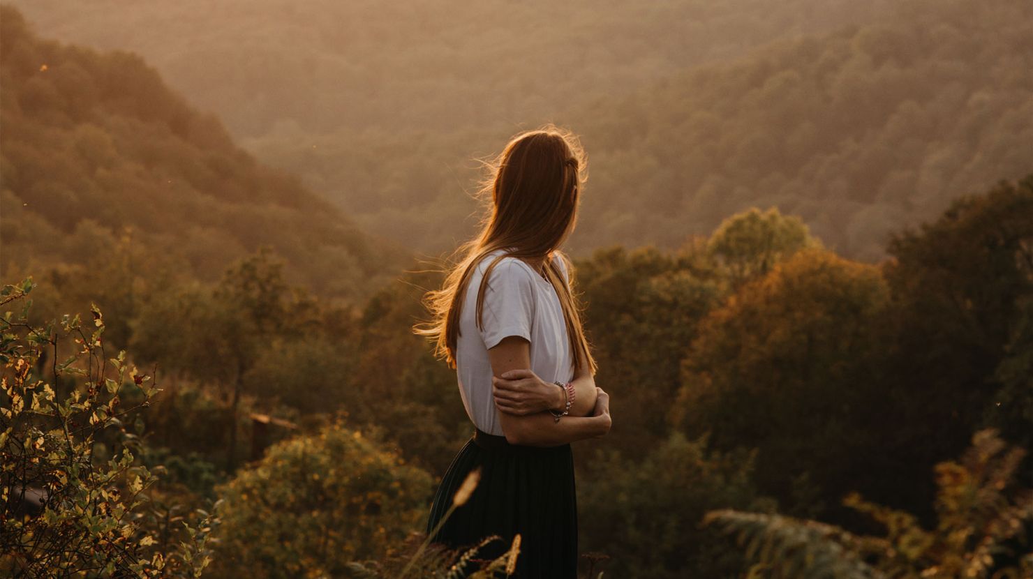 Woman looking away in the sunset