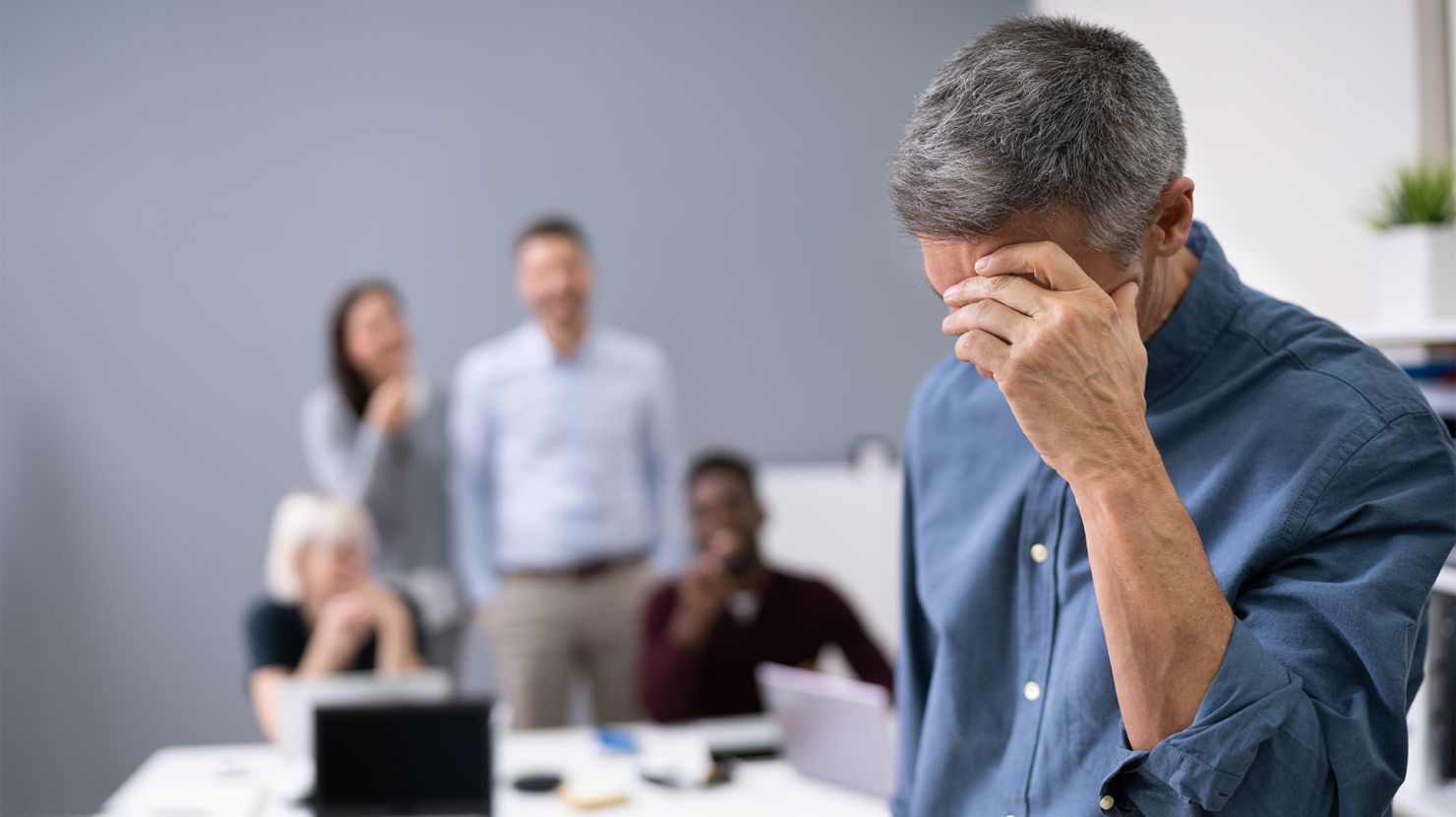 Overwhelmed businessman with his coworkers