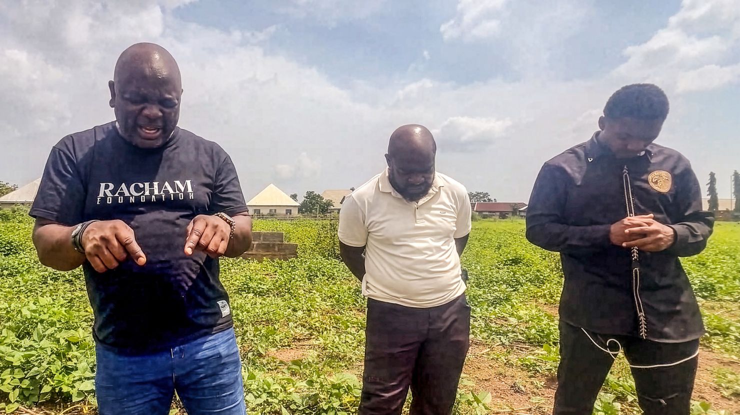 Pastor David leads his team in prayer on the grounds of the future care center site.