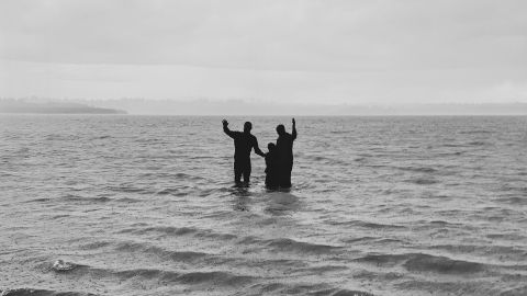 Man and Child getting baptized